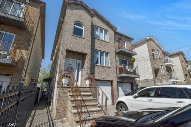 127 Brill St, Newark City, NJ 07105 - view of front of home featuring brick siding, an attached garage, and fence