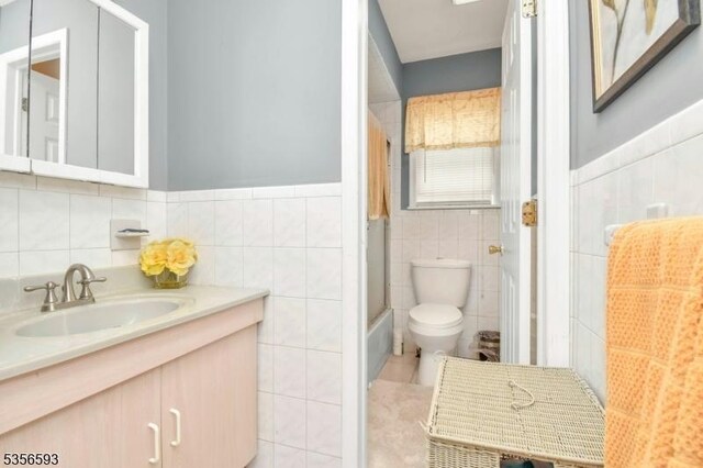 127 Brill St, Newark City, NJ 07105 - full bath featuring tile walls, toilet, vanity, tile patterned flooring, and wainscoting