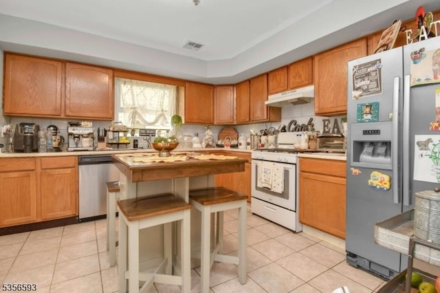 127 Brill St, Newark City, NJ 07105 - kitchen featuring stainless steel appliances, under cabinet range hood, light countertops, and light tile patterned floors