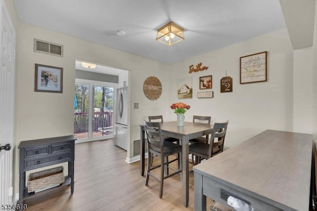 dining area with wood finished floors and baseboards