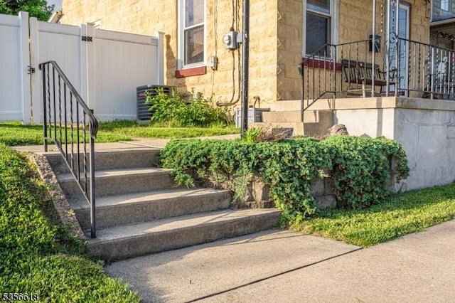 view of yard featuring central AC, fence, and a gate