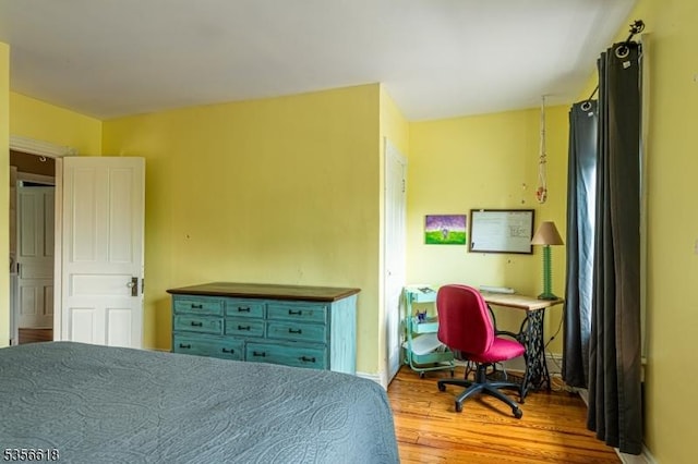 bedroom featuring wood finished floors and baseboards