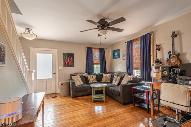 living area with light wood-style flooring and ceiling fan
