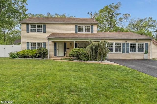 traditional-style home with driveway and covered porch