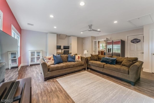 living area with attic access, wood finished floors, ceiling fan, recessed lighting, and baseboards