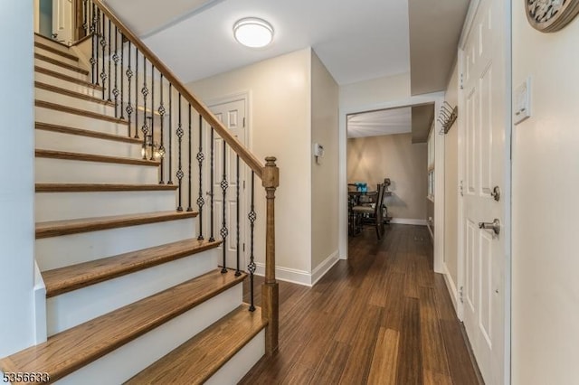 staircase with wood finished floors and baseboards