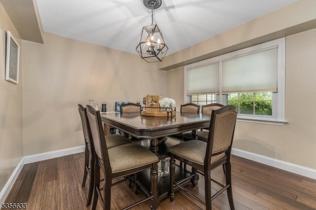dining room with baseboards, wood finished floors, and a chandelier