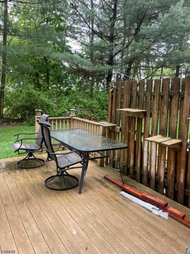 wooden deck featuring outdoor dining area