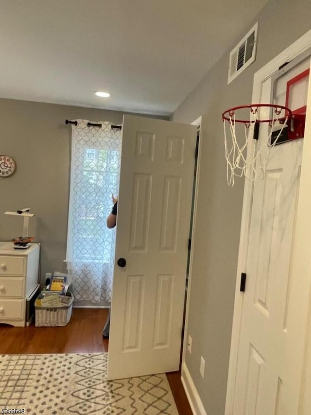entryway with dark wood-style flooring and recessed lighting