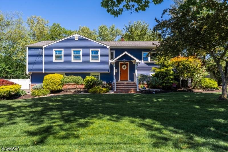 60 Wheatsheaf Rd, Clark Twp, NJ 07066 - bi-level home featuring a front yard and a chimney