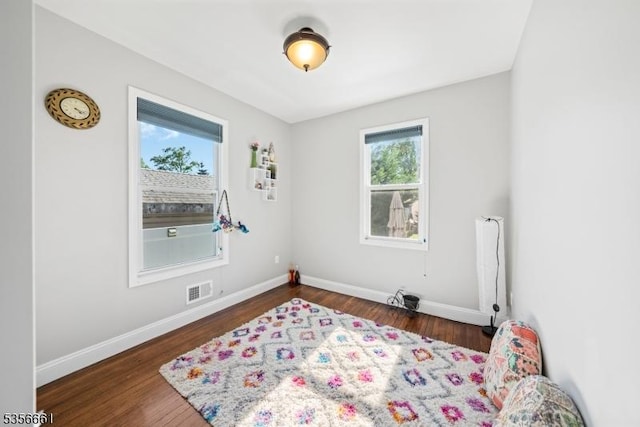 living area with wood finished floors and baseboards