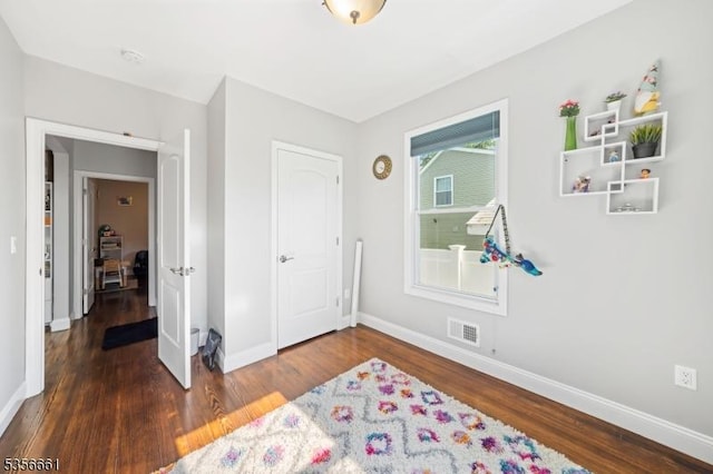 bedroom featuring wood finished floors and baseboards