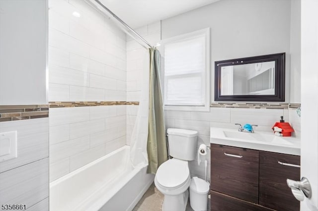 full bath featuring tile walls, vanity, toilet, and shower / tub combo with curtain