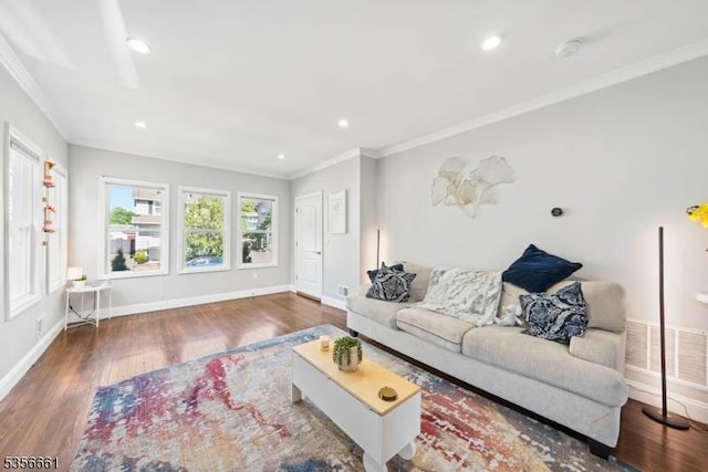 living area featuring wood finished floors, crown molding, baseboards, and recessed lighting