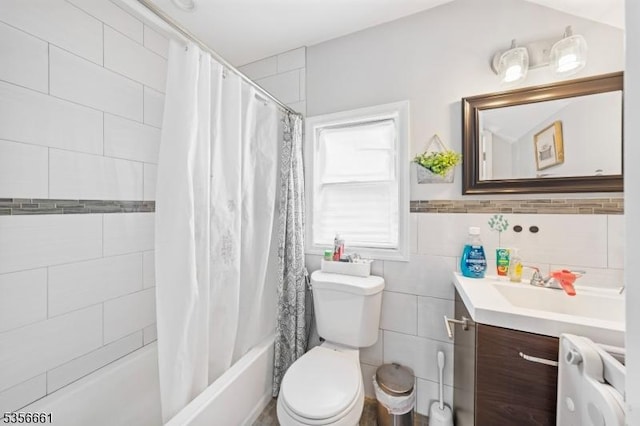bathroom featuring toilet, vanity, tile walls, and shower / tub combo with curtain