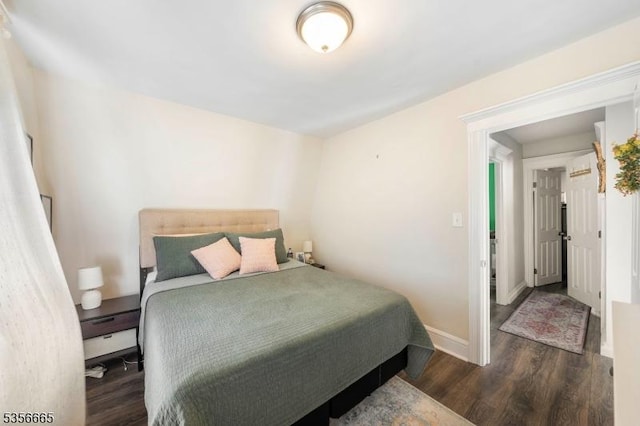 bedroom with wood finished floors and baseboards