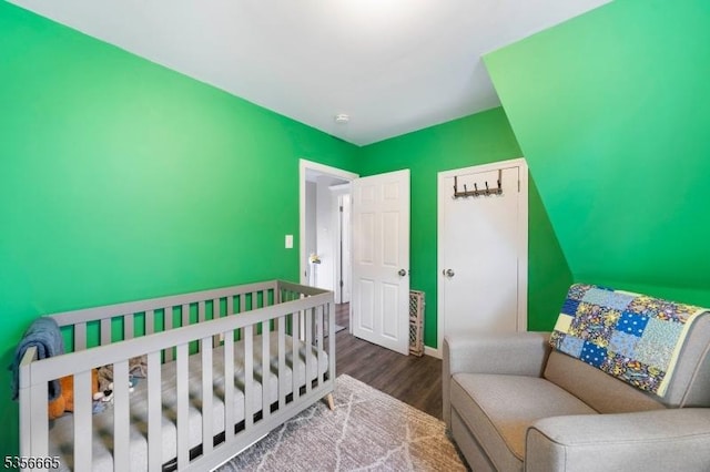 bedroom with wood finished floors and baseboards