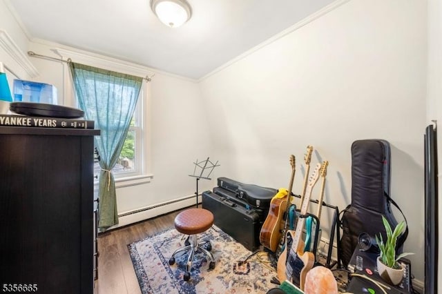 misc room with a baseboard radiator, crown molding, and wood finished floors