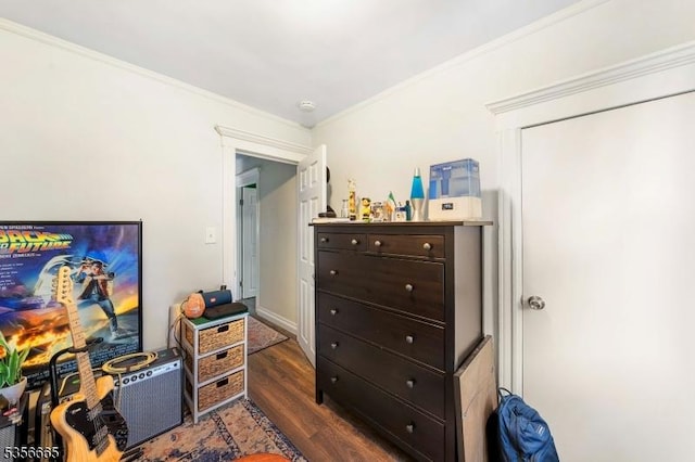 bedroom featuring dark wood-type flooring and crown molding