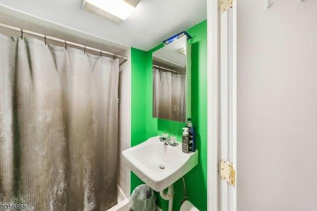 bathroom with a sink and a shower with curtain