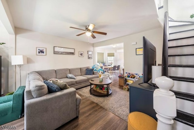 living area with wood finished floors and ceiling fan