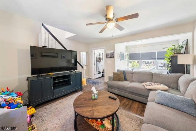 living room featuring stairway, a ceiling fan, and wood finished floors
