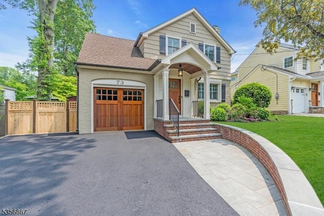 73 Lafayette Ave, Chatham Boro, NJ 07928 - view of front of home featuring asphalt driveway, a garage, brick siding, and roof with shingles