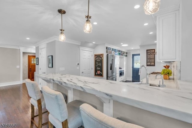 73 Lafayette Ave, Chatham Boro, NJ 07928 - kitchen featuring high end refrigerator, white cabinets, light stone counters, recessed lighting, and dark wood-type flooring