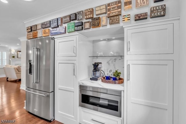 73 Lafayette Ave, Chatham Boro, NJ 07928 - kitchen featuring high end refrigerator, crown molding, white cabinetry, wood finished floors, and open floor plan