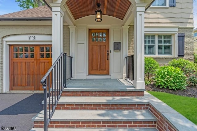 73 Lafayette Ave, Chatham Boro, NJ 07928 - entrance to property featuring asphalt driveway, a shingled roof, and brick siding