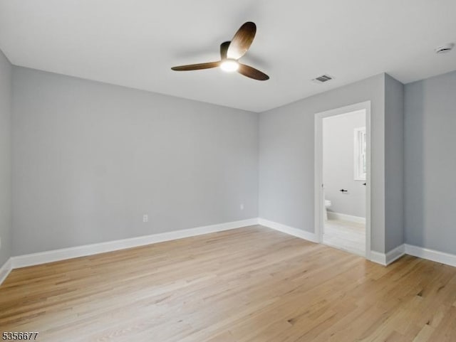 unfurnished bedroom with light wood-style floors, baseboards, connected bathroom, and ceiling fan