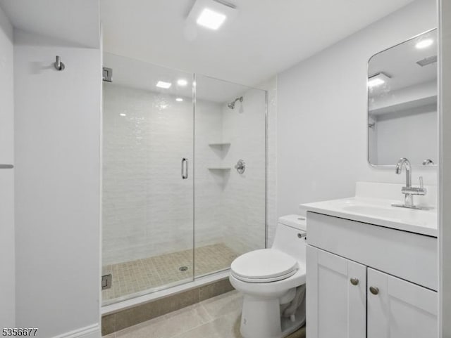 bathroom with tile patterned floors, toilet, a stall shower, and vanity