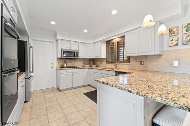 66 Skyline Dr, Morris Twp, NJ 07960 - kitchen featuring stainless steel appliances, light stone counters, white cabinetry, decorative backsplash, and ornamental molding