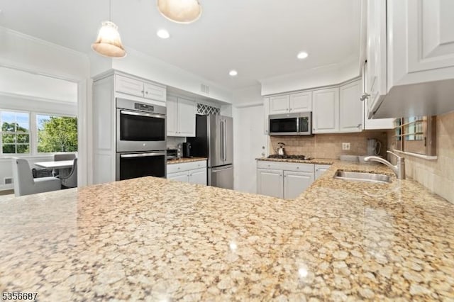 66 Skyline Dr, Morris Twp, NJ 07960 - kitchen with stainless steel appliances, a sink, white cabinets, light stone countertops, and decorative backsplash