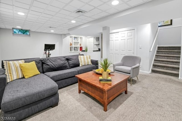 living area with light colored carpet, stairs, recessed lighting, baseboards, and a drop ceiling