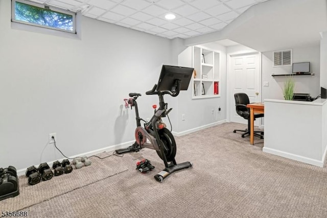 workout room featuring carpet floors and baseboards