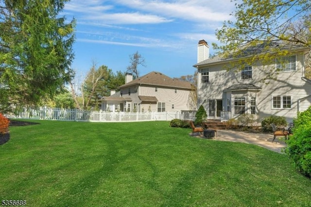 back of property with a patio and a chimney