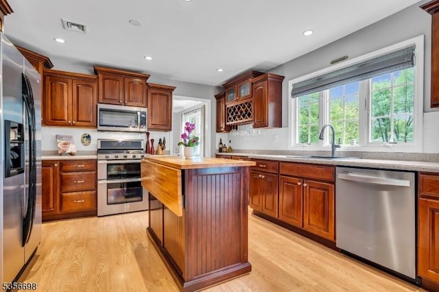 23 Andover Dr, Branchburg Twp, NJ 08853 - kitchen featuring appliances with stainless steel finishes, a sink, light wood finished floors, recessed lighting, and a center island
