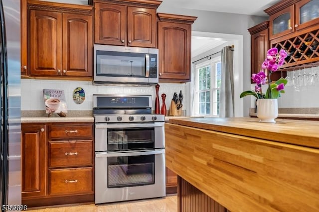 23 Andover Dr, Branchburg Twp, NJ 08853 - kitchen with stainless steel appliances, butcher block counters, backsplash, and glass insert cabinets