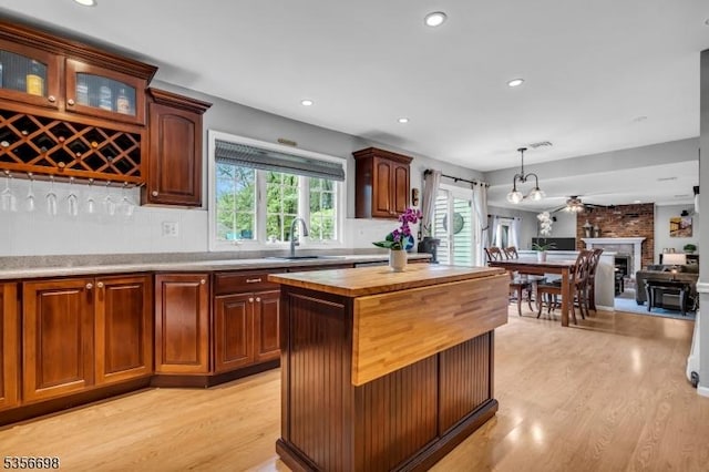 23 Andover Dr, Branchburg Twp, NJ 08853 - kitchen with a sink, light wood-style floors, wood counters, backsplash, and pendant lighting