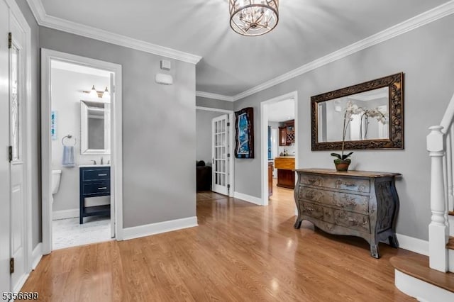 23 Andover Dr, Branchburg Twp, NJ 08853 - hallway with wood finished floors, ornamental molding, baseboards, a chandelier, and a sink