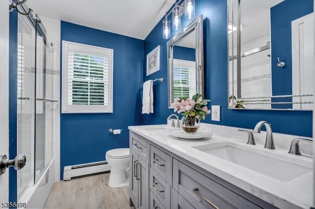 23 Andover Dr, Branchburg Twp, NJ 08853 - bathroom featuring baseboard heating, wood finished floors, toilet, and double vanity