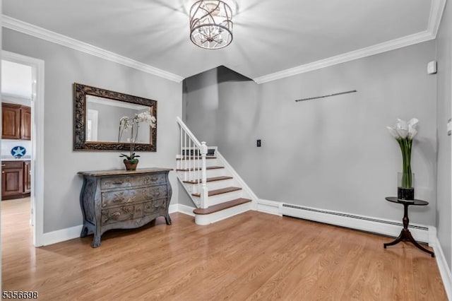 23 Andover Dr, Branchburg Twp, NJ 08853 - stairway featuring wood finished floors, ornamental molding, baseboards, a baseboard heating unit, and a chandelier