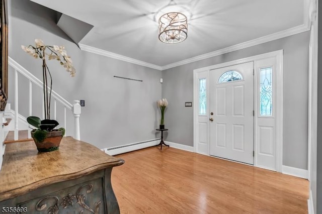 23 Andover Dr, Branchburg Twp, NJ 08853 - foyer entrance with baseboard heating, stairs, light wood-type flooring, ornamental molding, and a chandelier