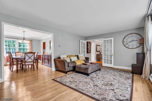 23 Andover Dr, Branchburg Twp, NJ 08853 - living area featuring a chandelier, light wood-style floors, french doors, and baseboards