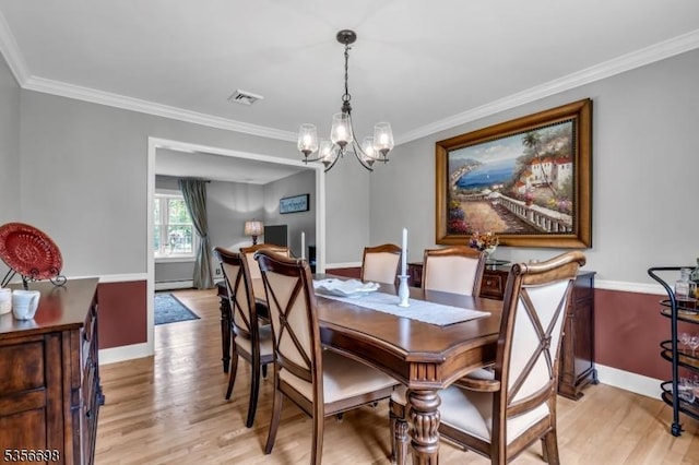 23 Andover Dr, Branchburg Twp, NJ 08853 - dining room featuring light wood-style flooring, a chandelier, ornamental molding, baseboards, and a baseboard radiator