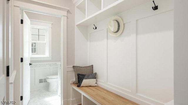 mudroom with a decorative wall