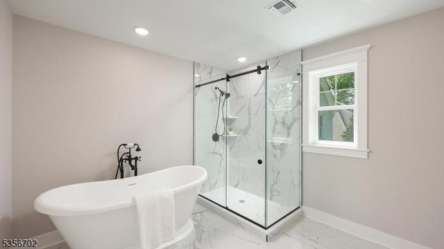 full bathroom with a marble finish shower, baseboards, a freestanding tub, marble finish floors, and recessed lighting
