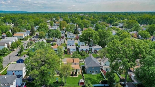 aerial view of residential area featuring a heavily wooded area
