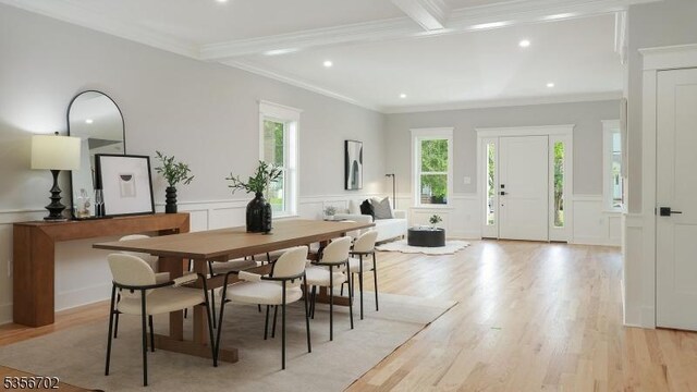 dining area featuring recessed lighting, light wood-style floors, and a decorative wall